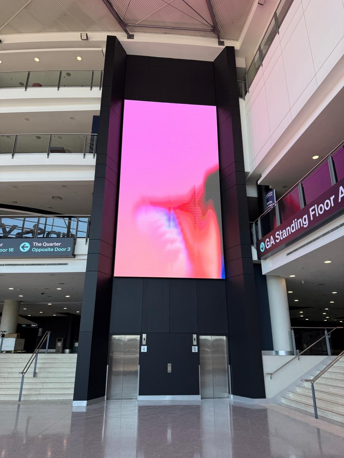 Traditional LED video wall at Afterpay Arena, spanning multiple levels above the lifts